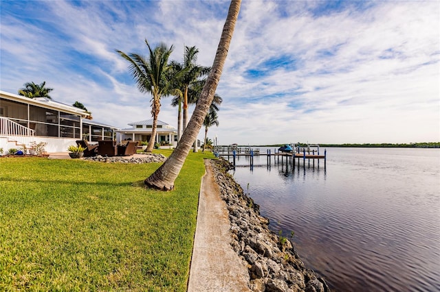 view of dock with a water view and a yard