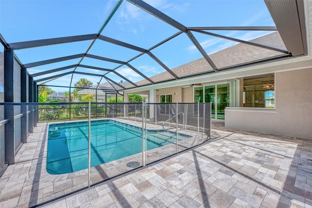 view of swimming pool with a patio and a lanai