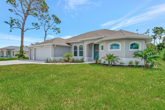 view of front of property with a garage and a front lawn