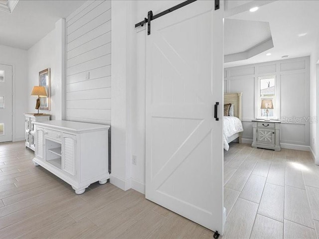 interior space featuring a barn door and light hardwood / wood-style floors