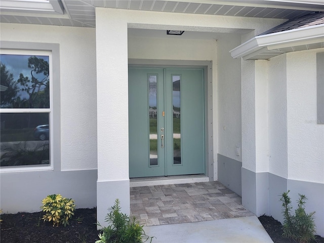 261 Broadmoor Ln, Rotonda West, FL 33947 - entrance to property featuring french doors and stucco siding