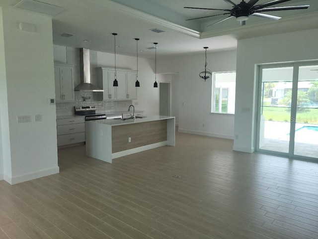 261 Broadmoor Ln, Rotonda West, FL 33947 - kitchen with wall chimney range hood, stainless steel electric range, ceiling fan, tasteful backsplash, and light countertops
