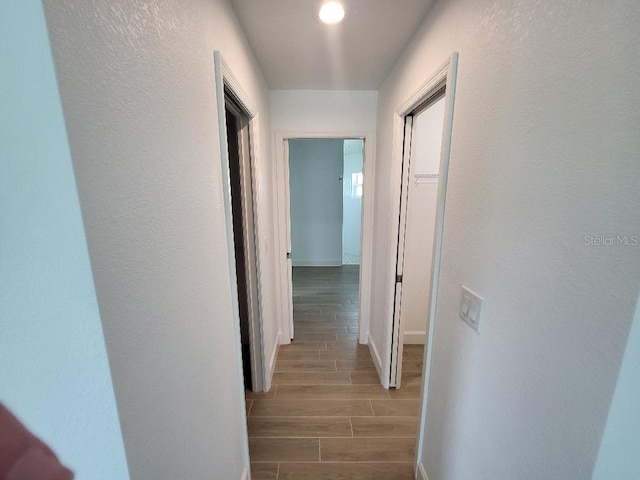 261 Broadmoor Ln, Rotonda West, FL 33947 - hallway featuring light wood-style flooring and baseboards