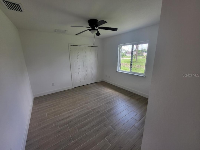 261 Broadmoor Ln, Rotonda West, FL 33947 - unfurnished bedroom featuring wood finished floors, a closet, and ceiling fan