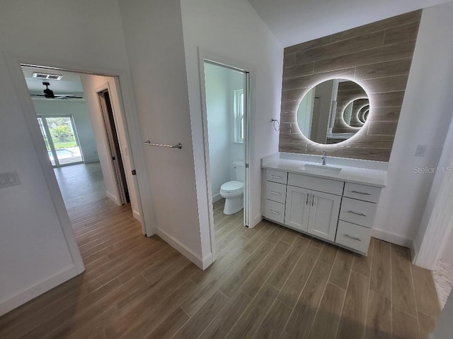 261 Broadmoor Ln, Rotonda West, FL 33947 - bathroom featuring wood finished floors, vanity, and a ceiling fan