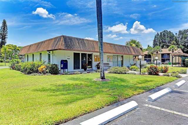 ranch-style home with a front lawn