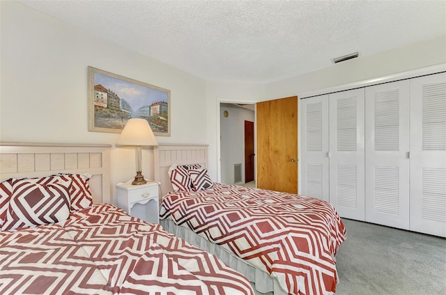 bedroom with a textured ceiling, a closet, and carpet floors