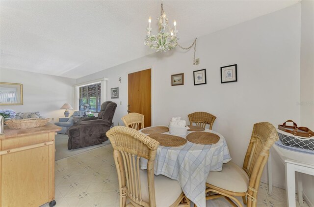 tiled dining space featuring a notable chandelier