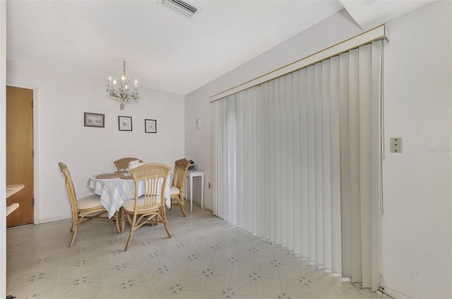 dining space featuring a notable chandelier and light tile patterned flooring