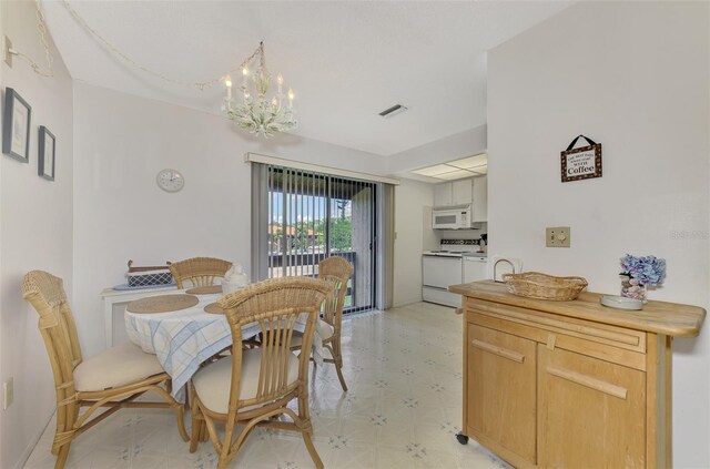 dining area with light tile patterned floors and a chandelier