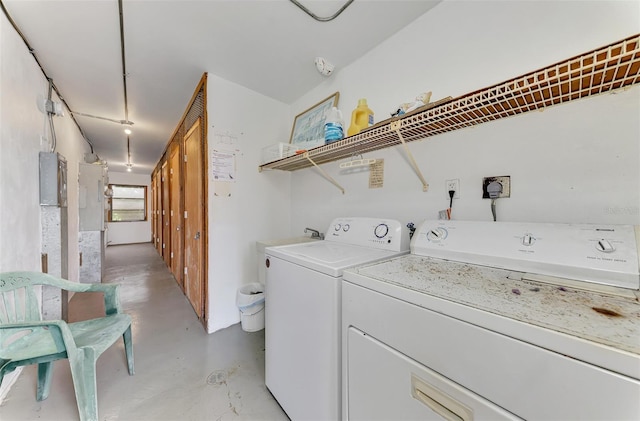 washroom featuring electric panel and washing machine and clothes dryer