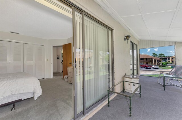 interior space with carpet flooring, a closet, and lofted ceiling