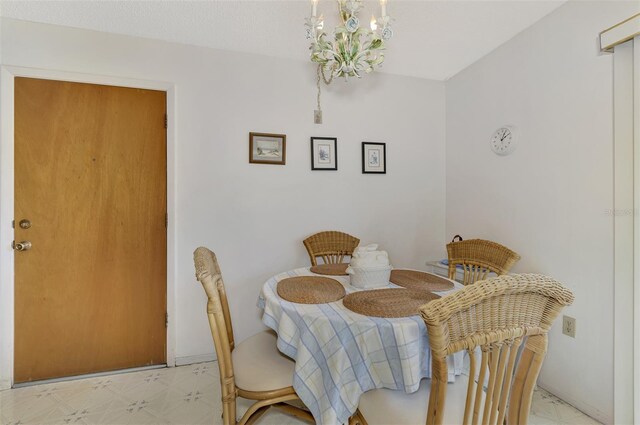 tiled dining space featuring a chandelier