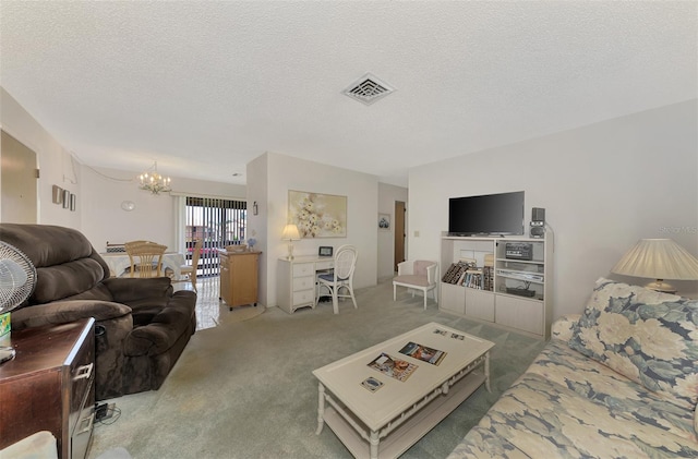 living room with a chandelier, a textured ceiling, and carpet