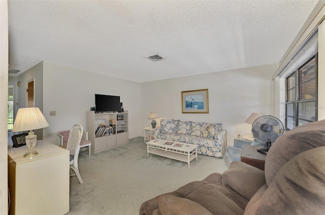 carpeted living room featuring a textured ceiling