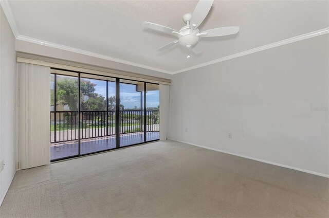 carpeted empty room with crown molding and ceiling fan