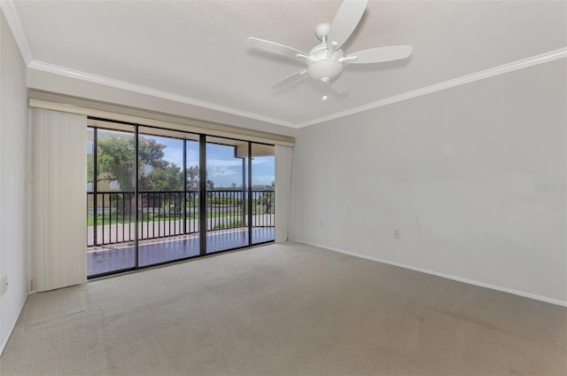 empty room with baseboards, a ceiling fan, crown molding, and light colored carpet