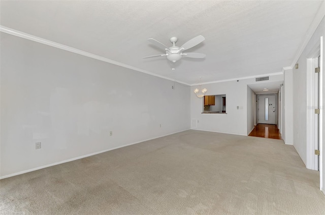 unfurnished living room with ceiling fan with notable chandelier, visible vents, light colored carpet, and ornamental molding