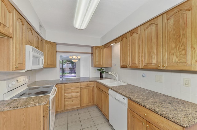 kitchen with white appliances, light tile patterned floors, tasteful backsplash, light stone countertops, and sink