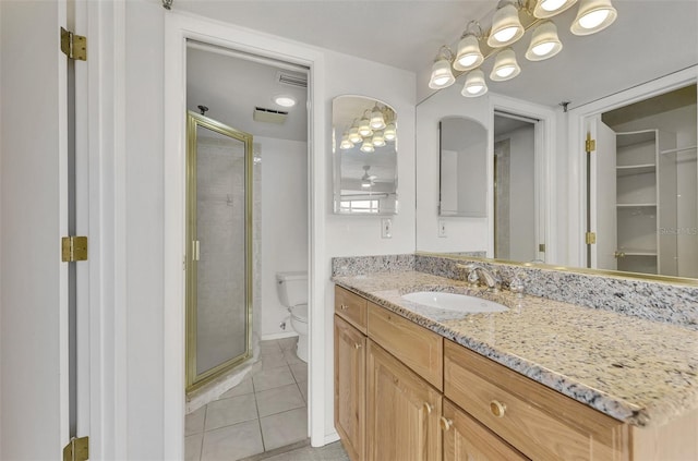 bathroom featuring a stall shower, visible vents, toilet, tile patterned flooring, and vanity