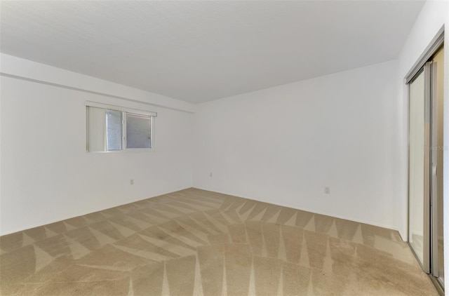 unfurnished room with light colored carpet