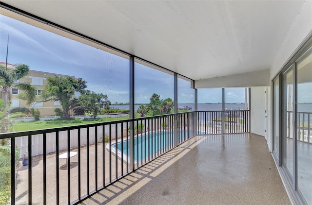 unfurnished sunroom with a water view