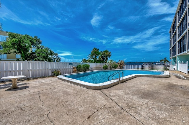 pool featuring a patio area and fence