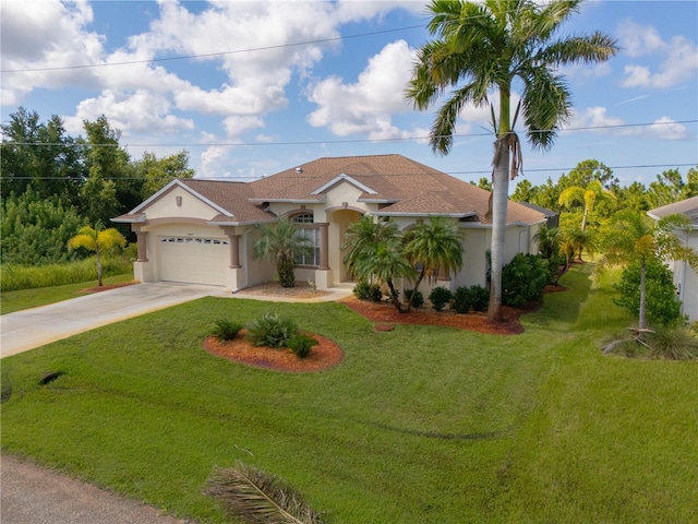 view of front of house with a front yard and a garage