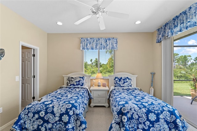 carpeted bedroom with multiple windows and ceiling fan