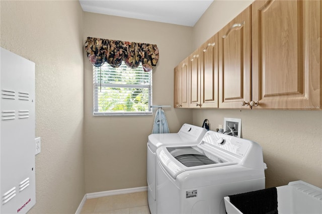 laundry area featuring cabinets, independent washer and dryer, and light tile patterned floors