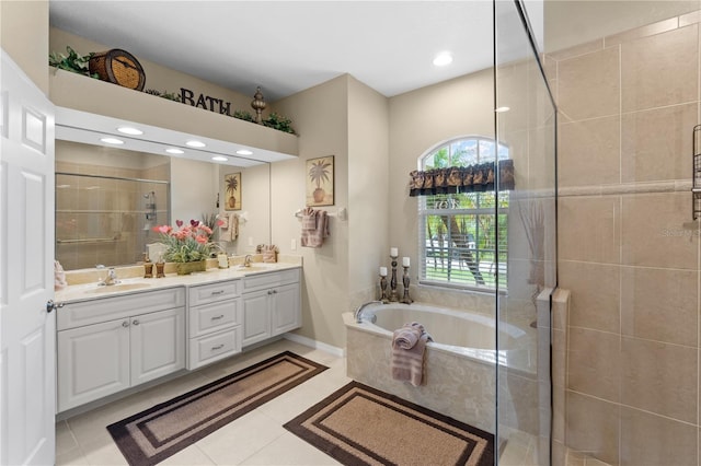 bathroom with tile patterned floors, vanity, and separate shower and tub