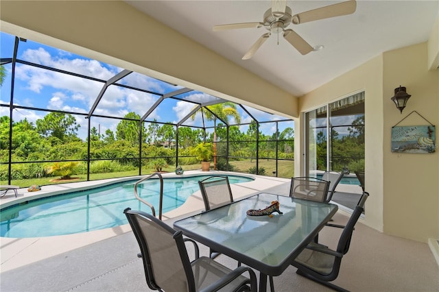 view of swimming pool with ceiling fan, a lanai, and a patio