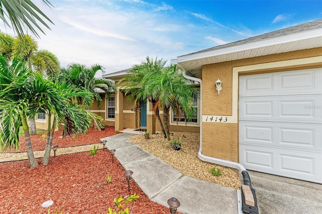 view of exterior entry with a garage