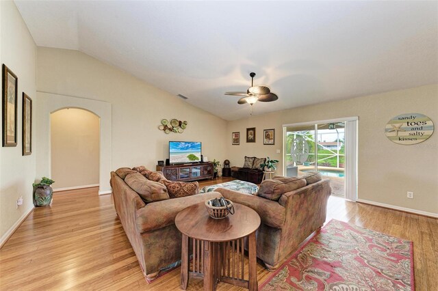 living room featuring ceiling fan, light wood-type flooring, and lofted ceiling