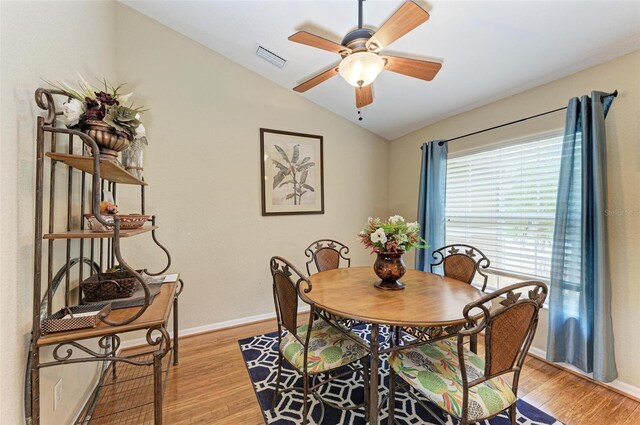 dining room featuring ceiling fan, light wood-type flooring, and lofted ceiling