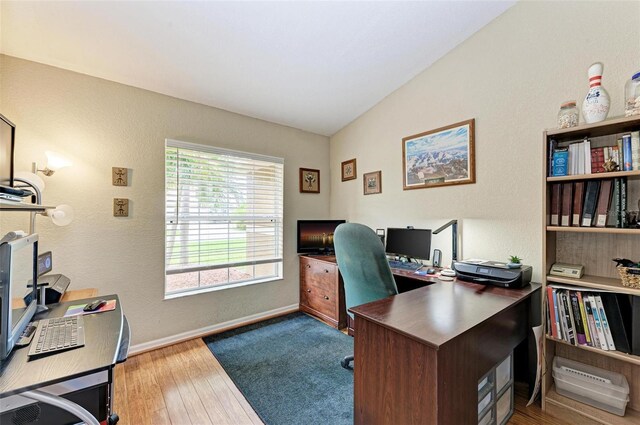 office area featuring vaulted ceiling and hardwood / wood-style flooring