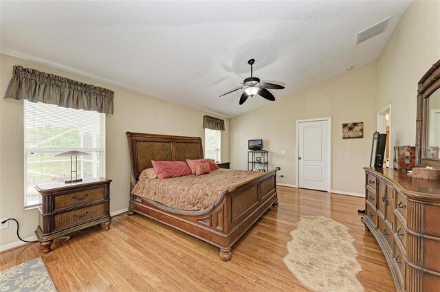 bedroom with ceiling fan, light wood-type flooring, and lofted ceiling