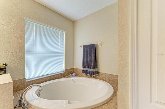 bathroom featuring tiled bath