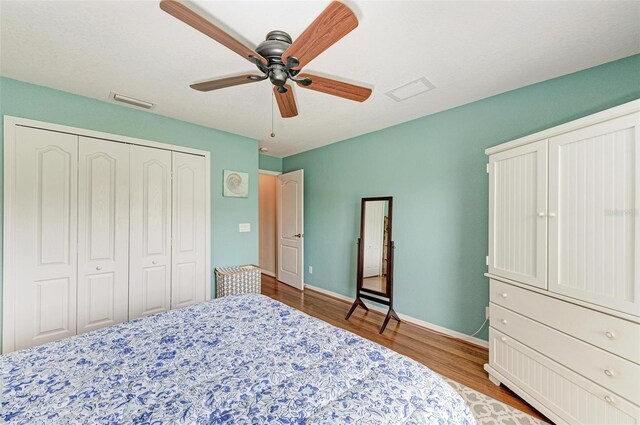 bedroom featuring light hardwood / wood-style flooring, a closet, and ceiling fan