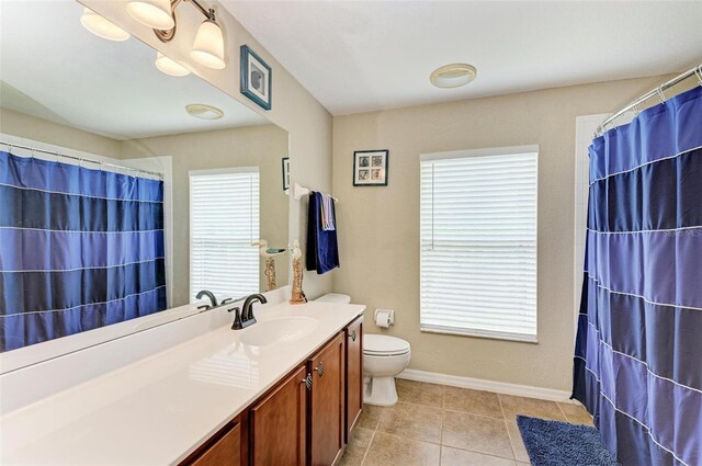 bathroom with vanity, toilet, and tile patterned flooring