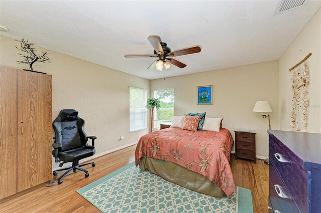 bedroom with ceiling fan and light hardwood / wood-style floors