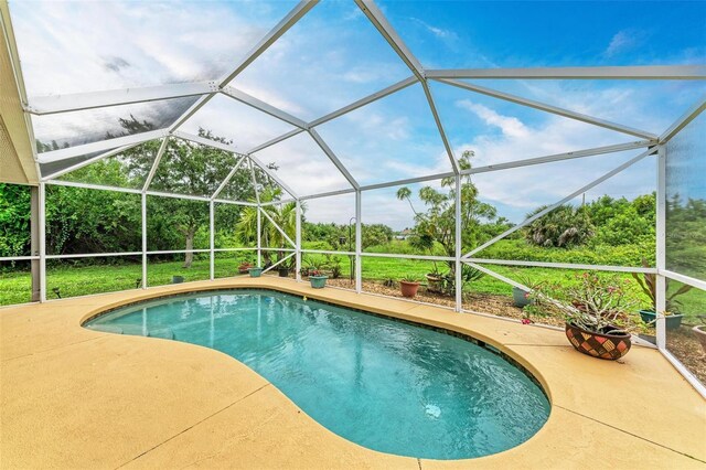 view of pool with a lanai and a patio