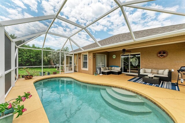 view of swimming pool with an outdoor hangout area, a patio, a lanai, and ceiling fan