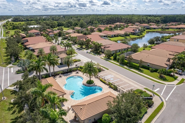 drone / aerial view with a residential view and a water view