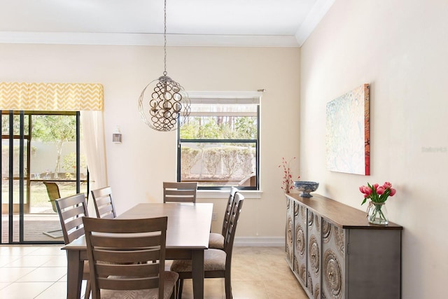 dining area with light tile patterned floors, ornamental molding, and baseboards