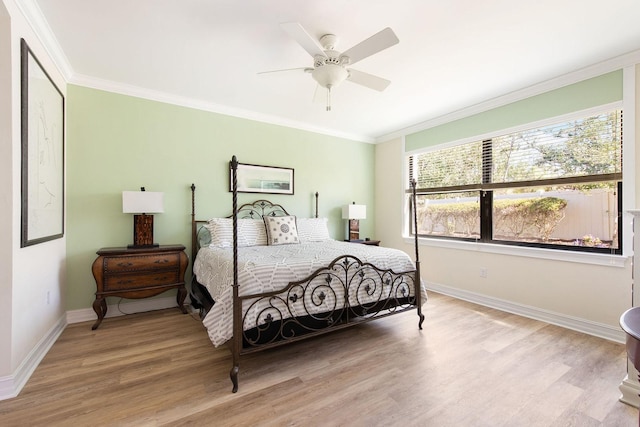 bedroom with baseboards, light wood-style flooring, and crown molding