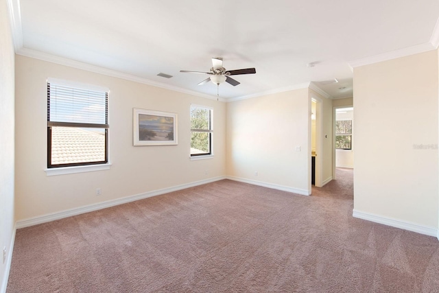 empty room with visible vents, baseboards, light colored carpet, ceiling fan, and ornamental molding