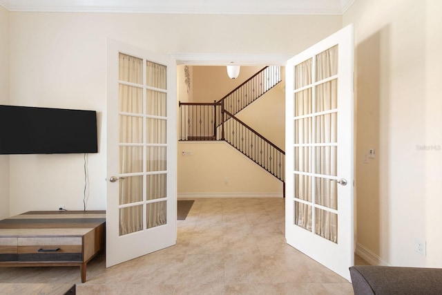 interior space with baseboards, stairs, ornamental molding, and french doors