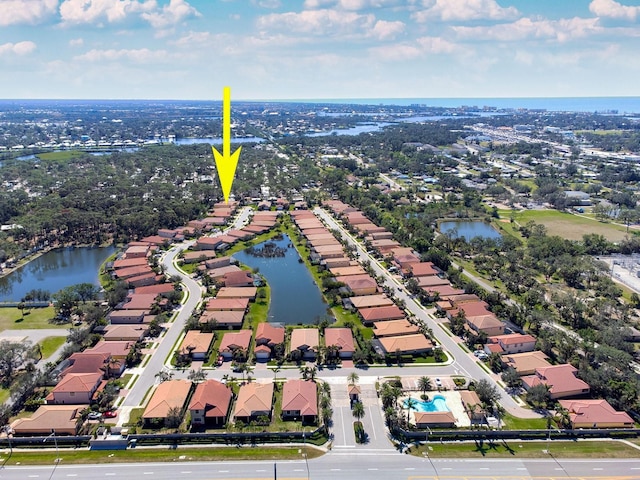 drone / aerial view featuring a water view and a residential view