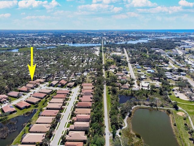 birds eye view of property with a water view and a residential view